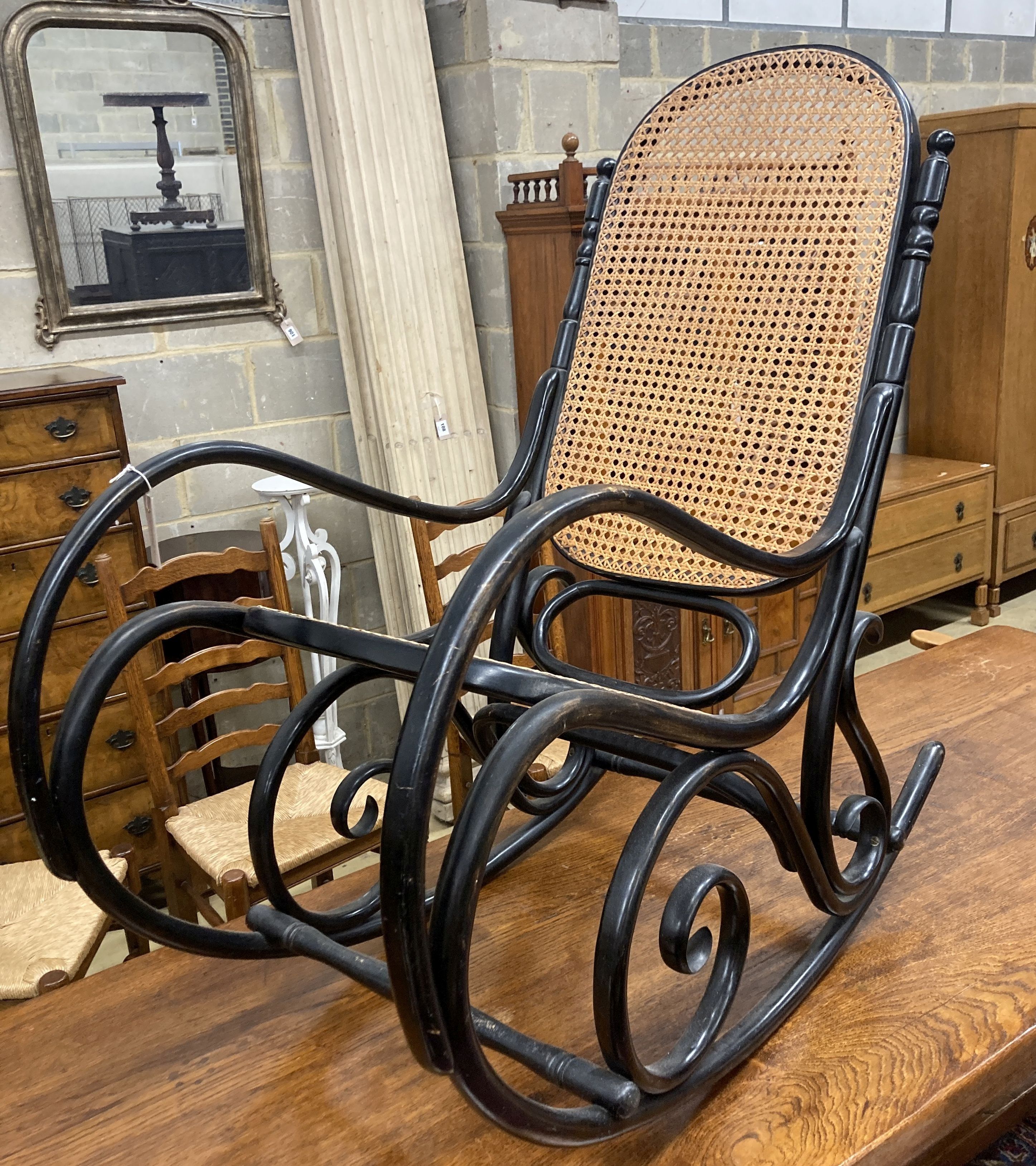 A Habitat 1970s ebonised bentwood caned rocking chair, width 50cm, depth 106cm, height 107cm